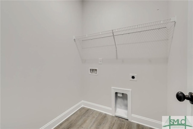 washroom with hookup for a washing machine, hardwood / wood-style floors, and hookup for an electric dryer