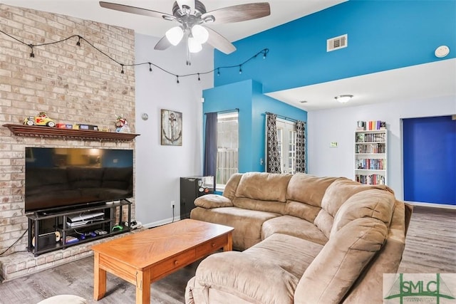 living room with ceiling fan and light hardwood / wood-style floors