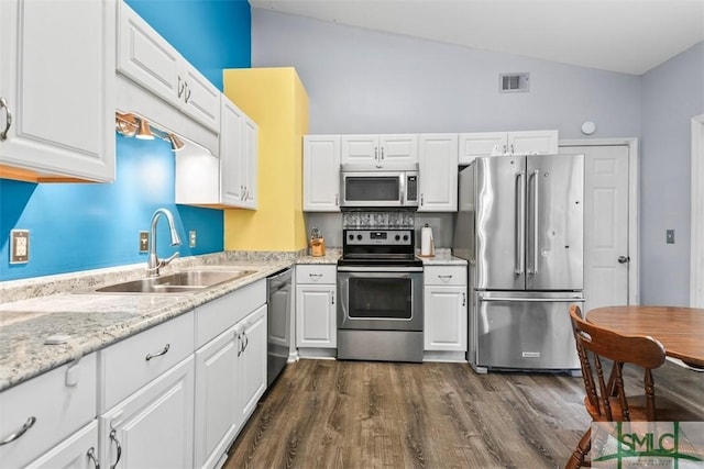 kitchen with dark hardwood / wood-style flooring, stainless steel appliances, sink, white cabinets, and lofted ceiling