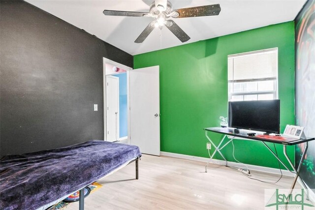 bedroom with ceiling fan and wood-type flooring