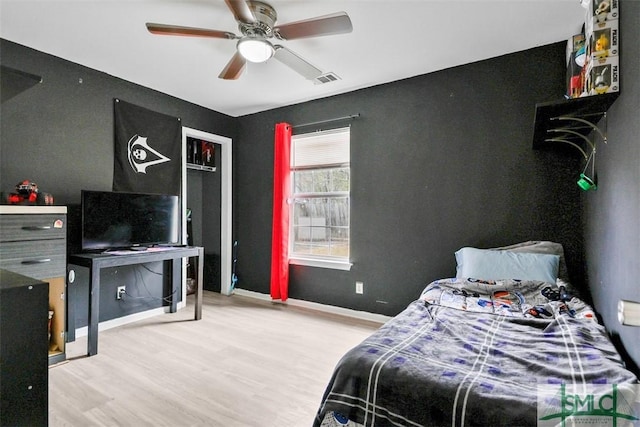 bedroom with hardwood / wood-style floors and ceiling fan