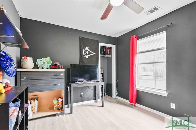 playroom with wood-type flooring and ceiling fan