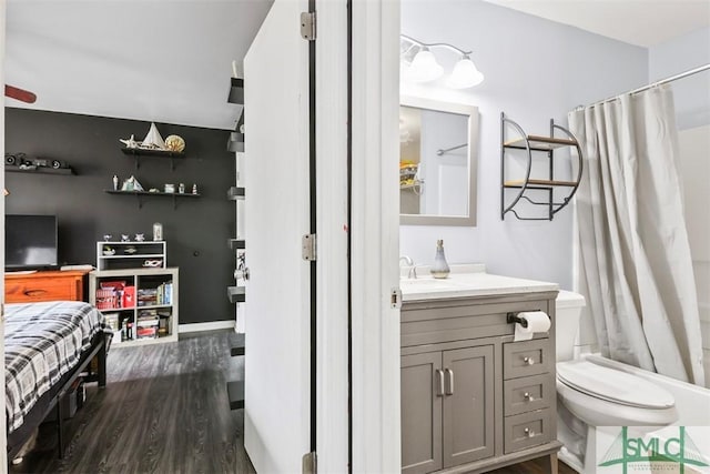 bathroom with hardwood / wood-style floors, vanity, and toilet