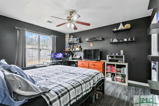 bedroom with ceiling fan and dark wood-type flooring