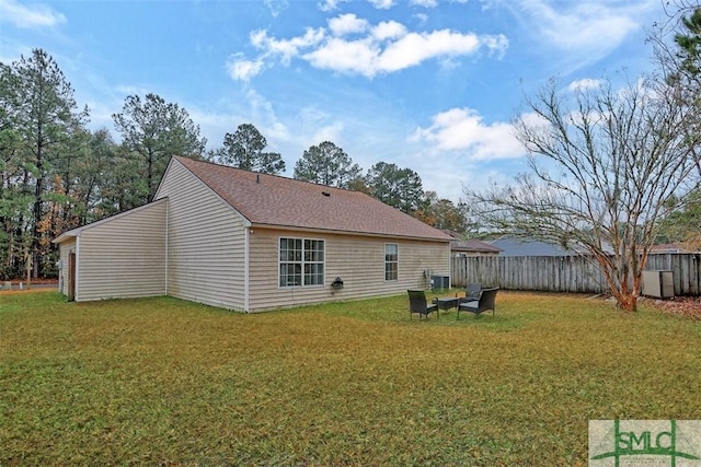 rear view of property with a lawn