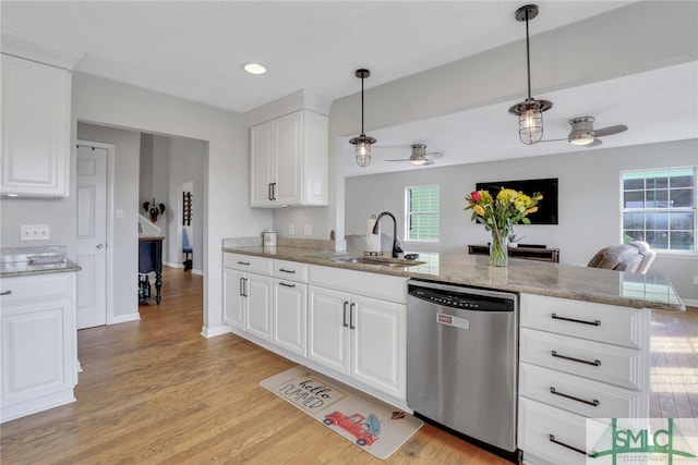 kitchen with dishwasher, sink, kitchen peninsula, pendant lighting, and white cabinets