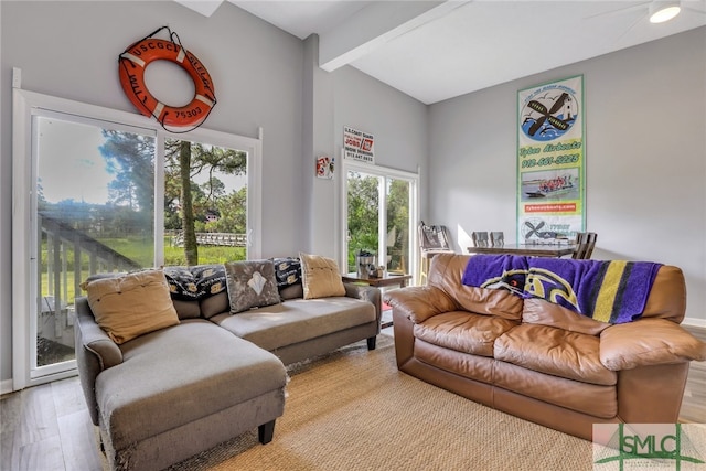 living room featuring beam ceiling and light wood-type flooring