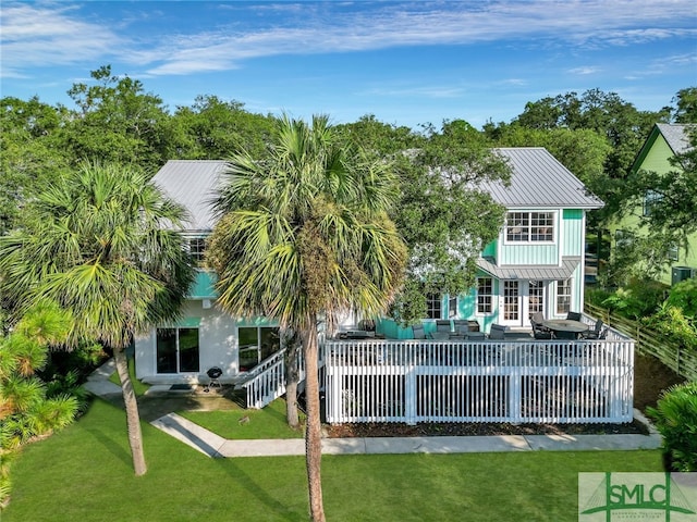 back of property featuring outdoor lounge area and a lawn