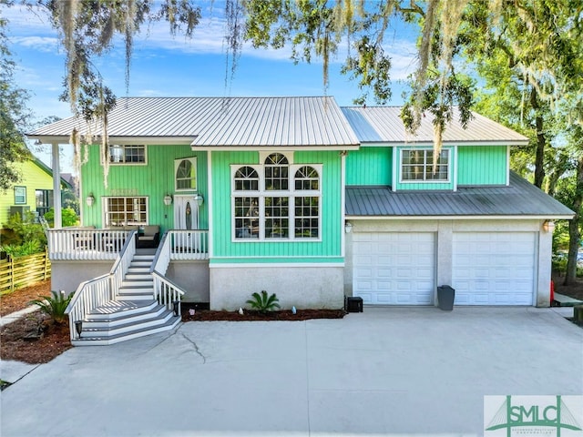 view of front of home with a porch and a garage