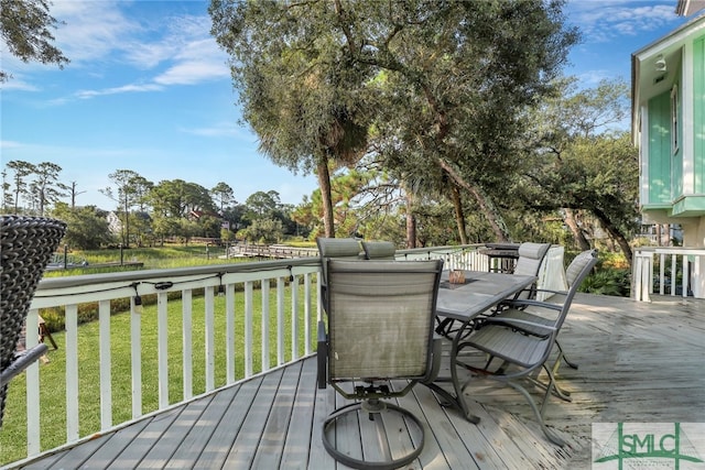 wooden terrace featuring a lawn