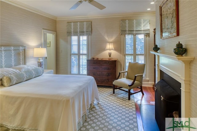 bedroom with ceiling fan, wood-type flooring, and ornamental molding