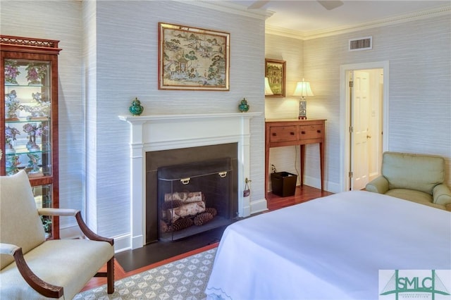 bedroom with ceiling fan, dark hardwood / wood-style flooring, and ornamental molding