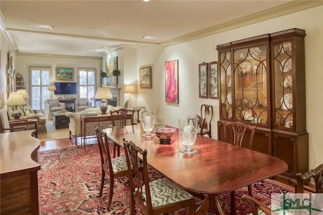 dining space with hardwood / wood-style floors and ornamental molding