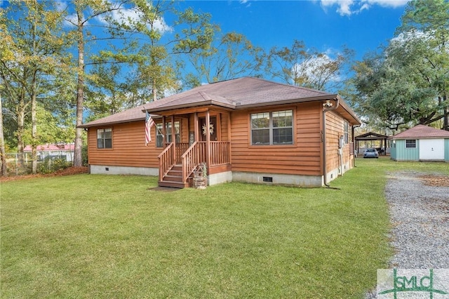 view of front of home with an outbuilding and a front yard