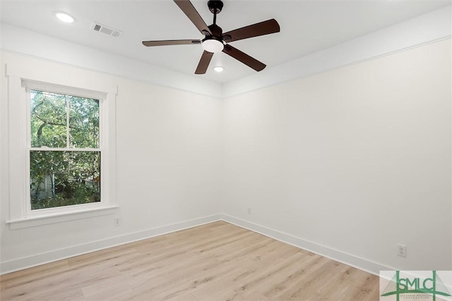 empty room with ceiling fan and light hardwood / wood-style flooring