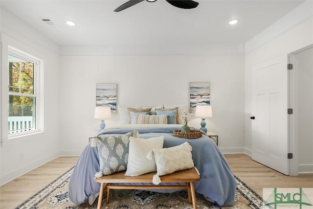 bedroom with ceiling fan and light hardwood / wood-style flooring