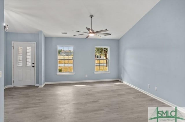 spare room featuring ceiling fan, vaulted ceiling, and light hardwood / wood-style flooring