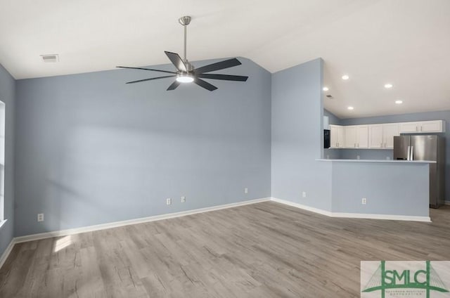 unfurnished living room with light wood-type flooring, ceiling fan, and lofted ceiling