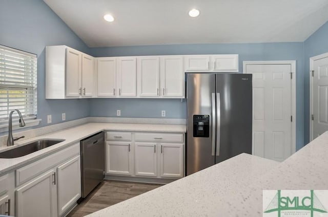 kitchen with dark wood-type flooring, white cabinetry, sink, and stainless steel appliances