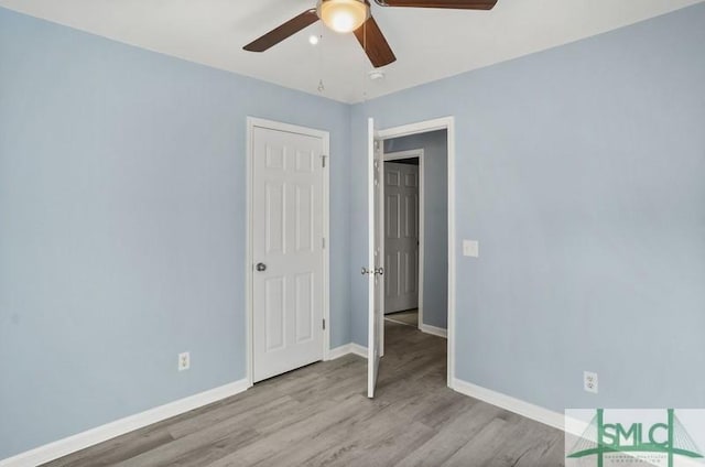 empty room featuring ceiling fan and light hardwood / wood-style flooring