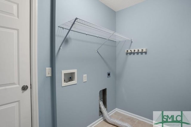 washroom featuring washer hookup, electric dryer hookup, and light tile patterned floors