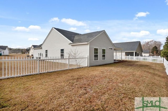 view of side of home with a yard