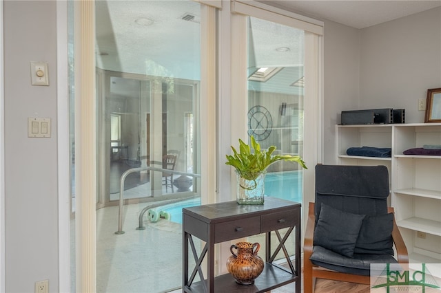 living area with hardwood / wood-style floors