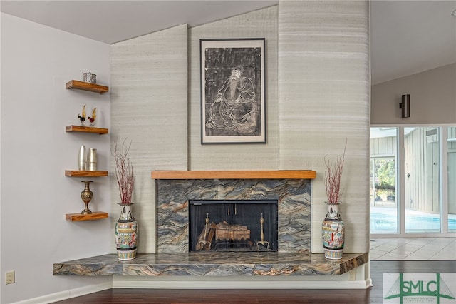 interior details with a stone fireplace and hardwood / wood-style flooring