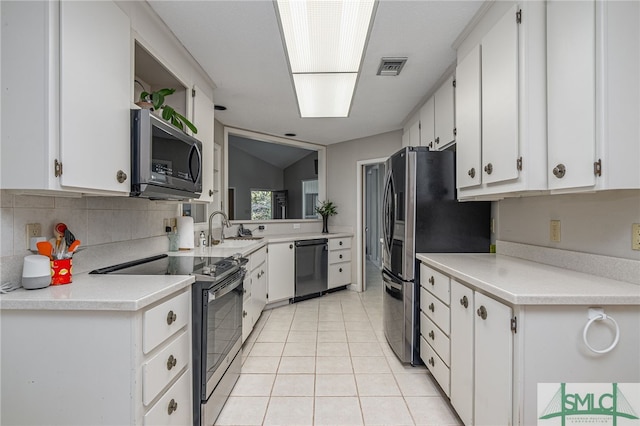 kitchen featuring white cabinets, lofted ceiling, and stainless steel appliances