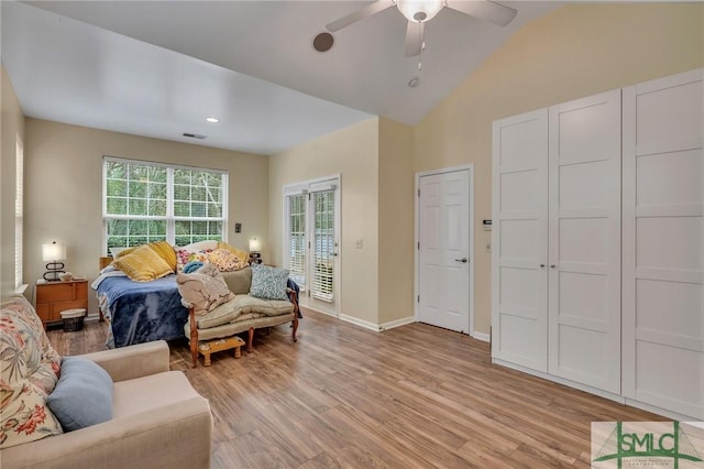 living room featuring light hardwood / wood-style floors, ceiling fan, and lofted ceiling