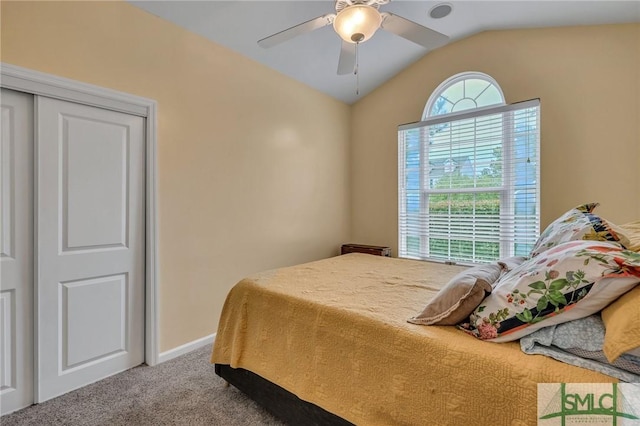 bedroom with carpet flooring, ceiling fan, a closet, and lofted ceiling