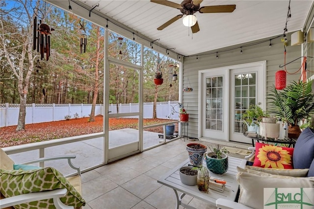 sunroom / solarium featuring a wealth of natural light and ceiling fan