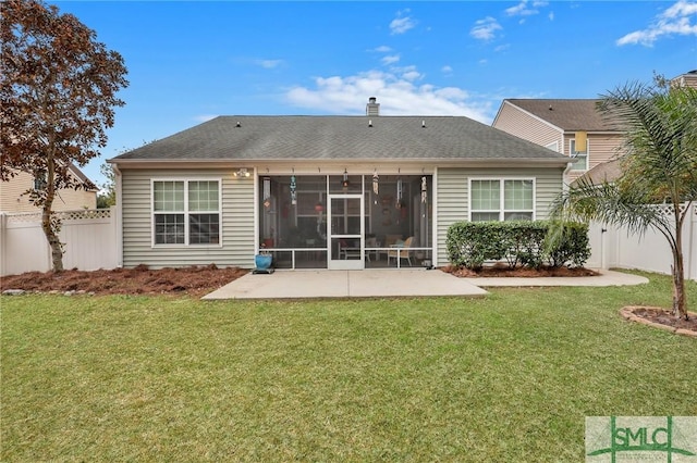 back of house with a yard and a patio