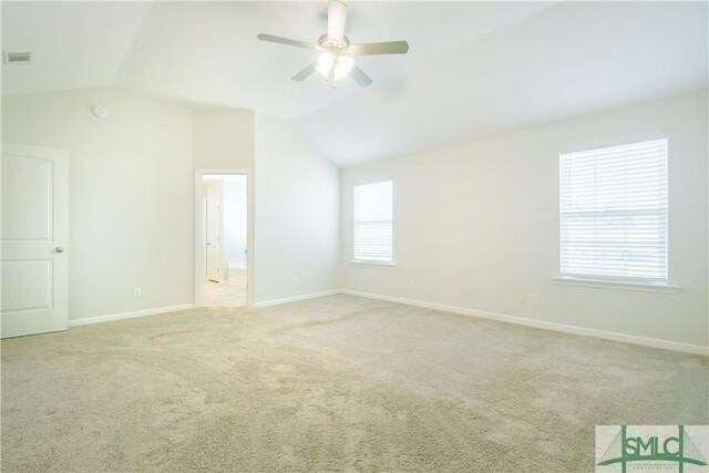 unfurnished room with ceiling fan, light carpet, and vaulted ceiling