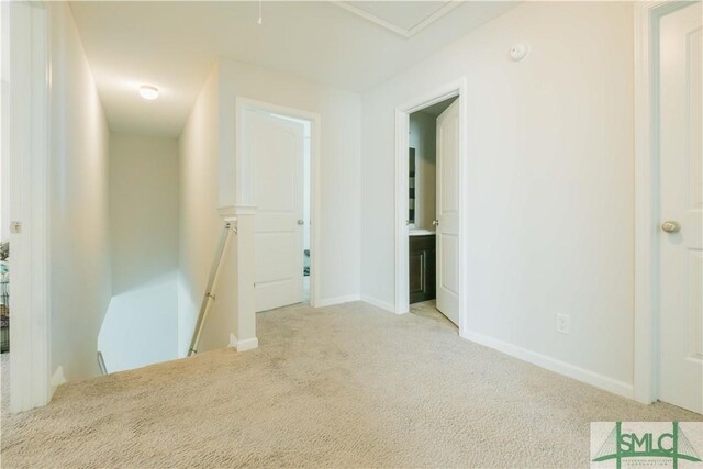 empty room featuring light carpet