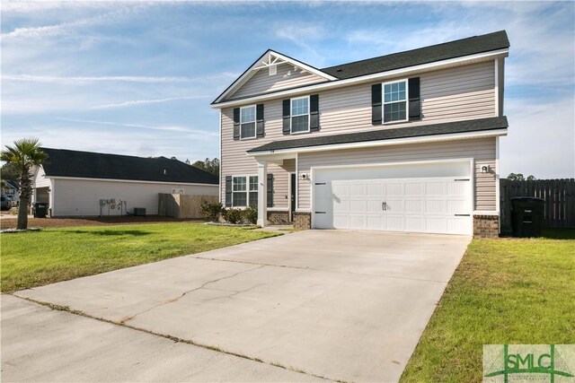 view of front of home featuring a front yard and a garage