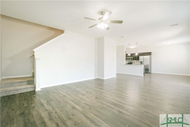 unfurnished living room with ceiling fan and dark hardwood / wood-style flooring