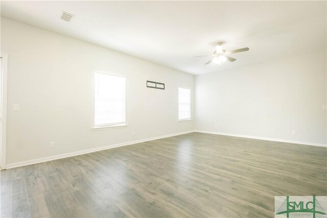 spare room featuring ceiling fan and dark hardwood / wood-style flooring