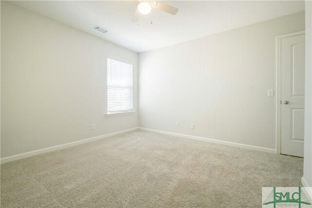 carpeted empty room featuring ceiling fan