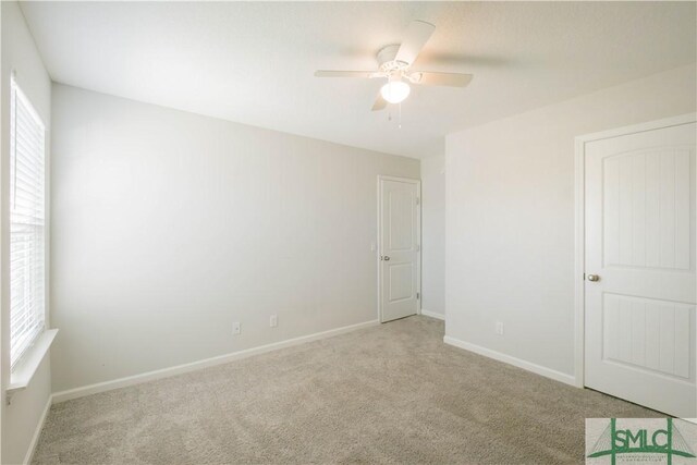 carpeted empty room with ceiling fan