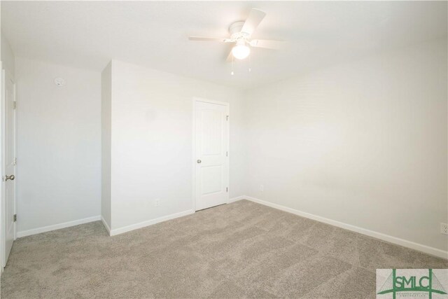 empty room with ceiling fan and light colored carpet