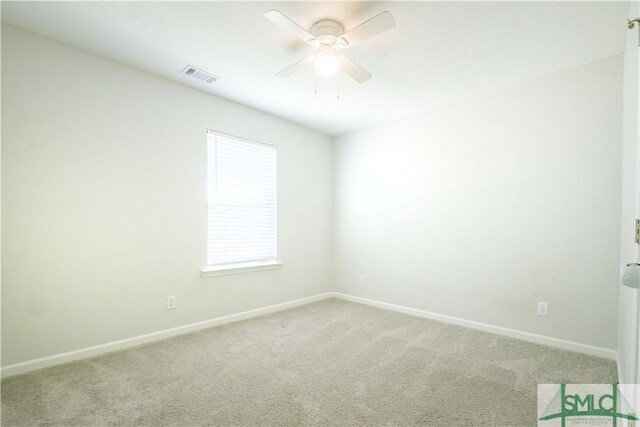 empty room with ceiling fan and carpet floors