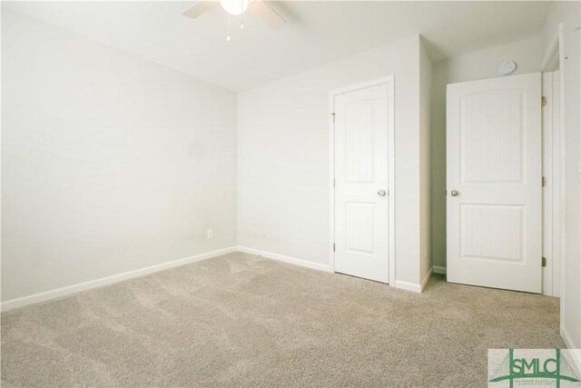 unfurnished bedroom featuring light colored carpet and ceiling fan