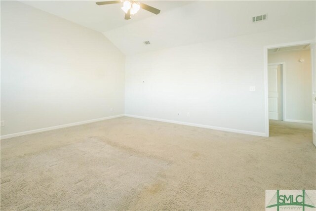 carpeted empty room with ceiling fan and vaulted ceiling