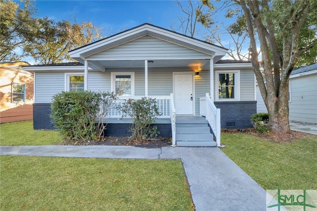 bungalow with a porch and a front lawn