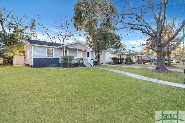 ranch-style house with covered porch and a front yard