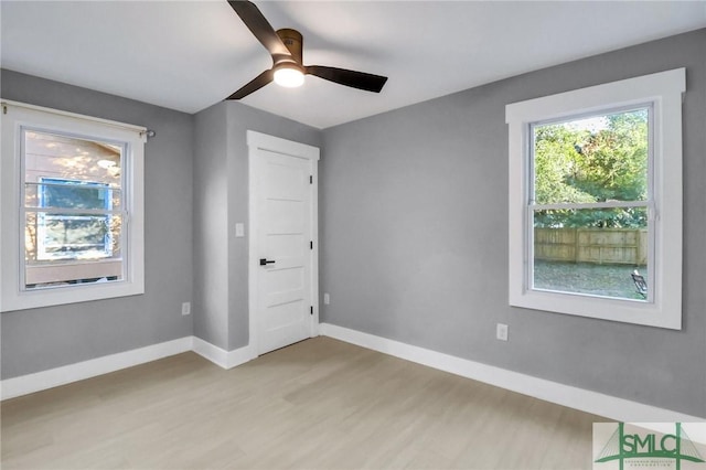 unfurnished bedroom with ceiling fan and light wood-type flooring