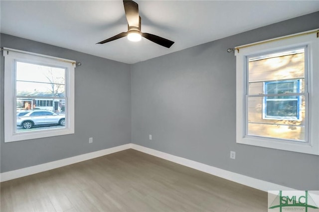 unfurnished room with hardwood / wood-style flooring and ceiling fan