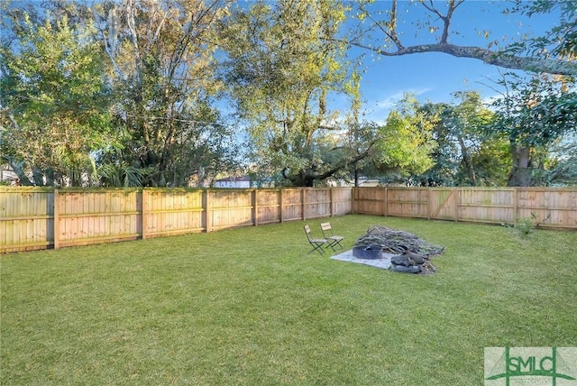 view of yard with an outdoor fire pit