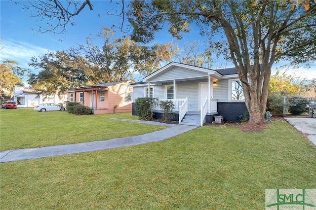 view of front facade with covered porch and a front yard